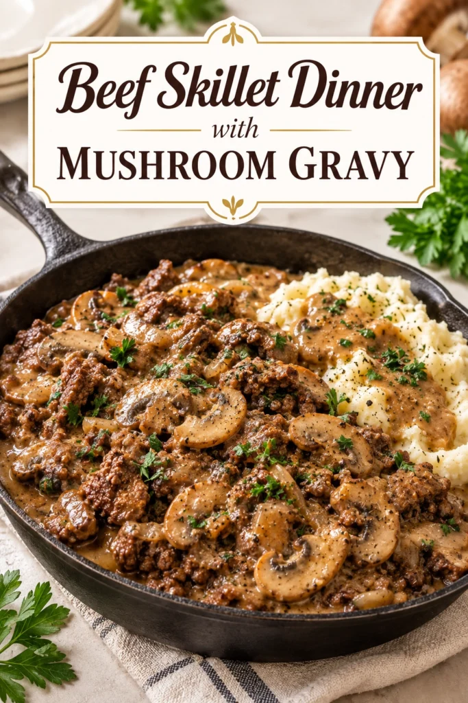 Beef chunks and sliced mushrooms in a rich brown gravy served in a cast iron skillet with fresh parsley.